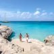 Tres Trapi Steps Triple Steps Beach, Aruba, Popular beach among locals and tourists for diving and snorkeling, couple man and woman in a crystal clear ocean in the Caribbean