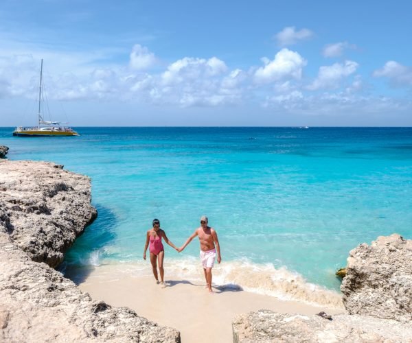 Tres Trapi Steps Triple Steps Beach, Aruba, Popular beach among locals and tourists for diving and snorkeling, couple man and woman in a crystal clear ocean in the Caribbean