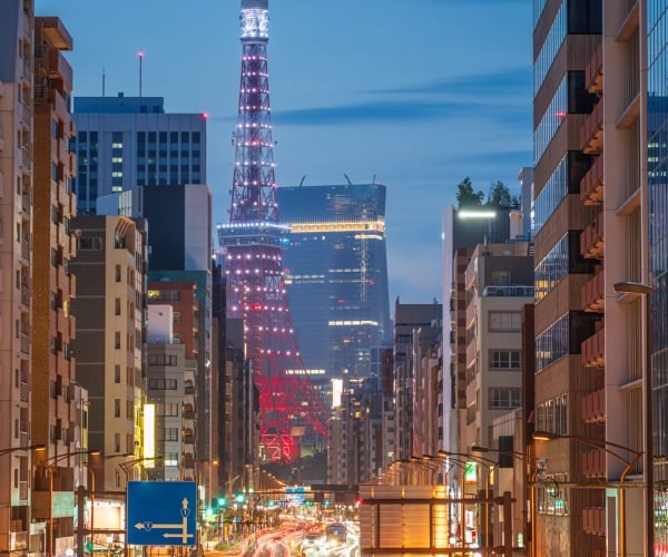 Tokyo, Japan with Tokyo Tower over traffic at twilight.
